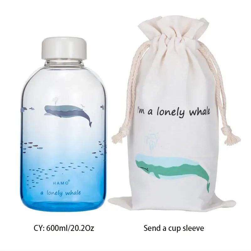 Clear glass water bottle with decorbites blue glass gradient featuring whale and fish, topped with white screw cap