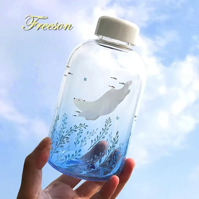Clear glass water bottle with white lid featuring gray seal and blue aquatic plants design for decorbites blue glass water