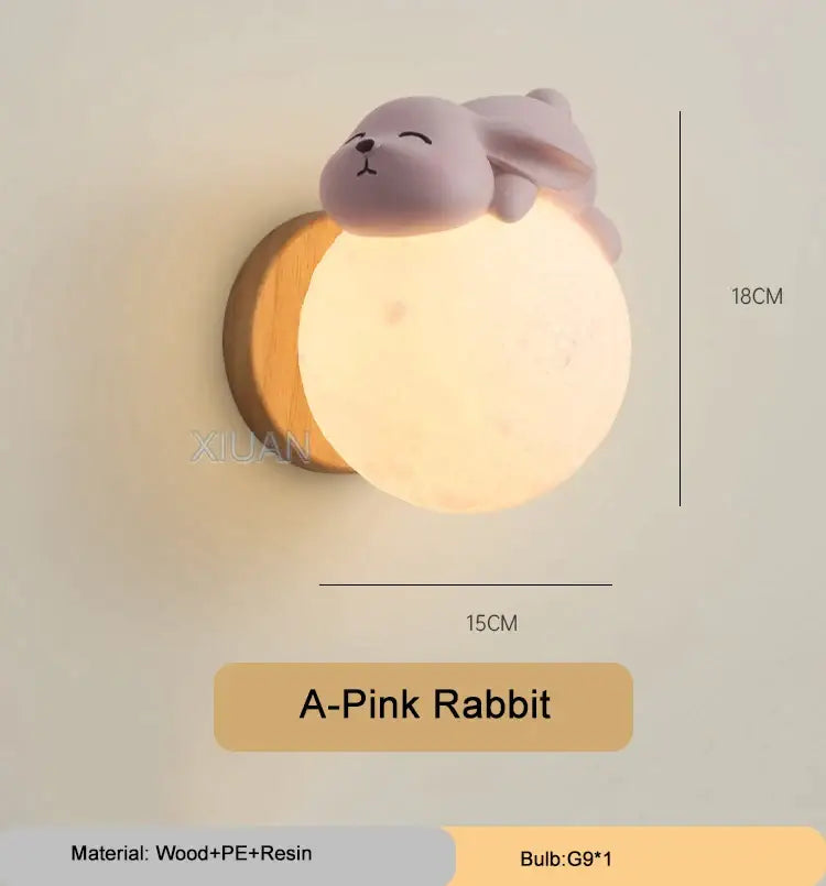 A soft pink rabbit-shaped resin wall light with wooden base providing warm ambient lighting for bedroom decorbites cartoon animal decor