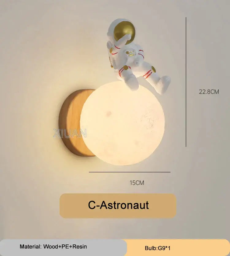 White astronaut figurine perched on glowing moon-shaped wall light with wooden base decorbites cartoon animal wall light