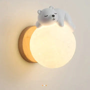 Cute white polar bear cartoon animal wall light with warm glowing circular light and wooden base for bedroom decorbites wall light