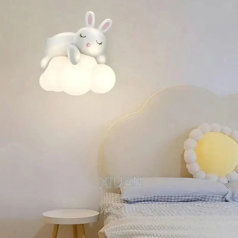 Cute polar bear wall lamp shaped like a white bunny with closed eyes and pink nose resting on a soft cloud base