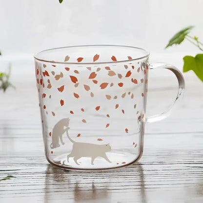 Clear glass coffee mug with orange and beige leaf patterns and cat silhouettes heat resistant for kitchen use