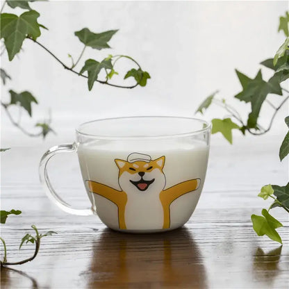 Clear glass coffee mug with a cheerful yellow and white shiba inu design filled with milk for kitchen use