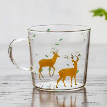 Clear glass coffee mug with two golden deer and green leaves decorative design heat resistant for tea and coffee