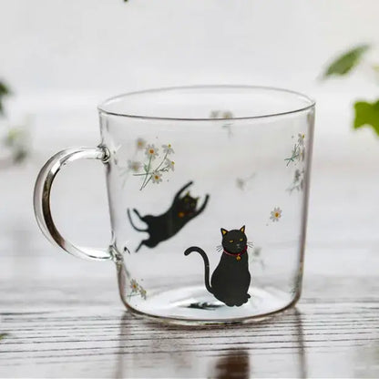Clear glass coffee mug with black cat illustrations and white daisies heat resistant for kitchen use