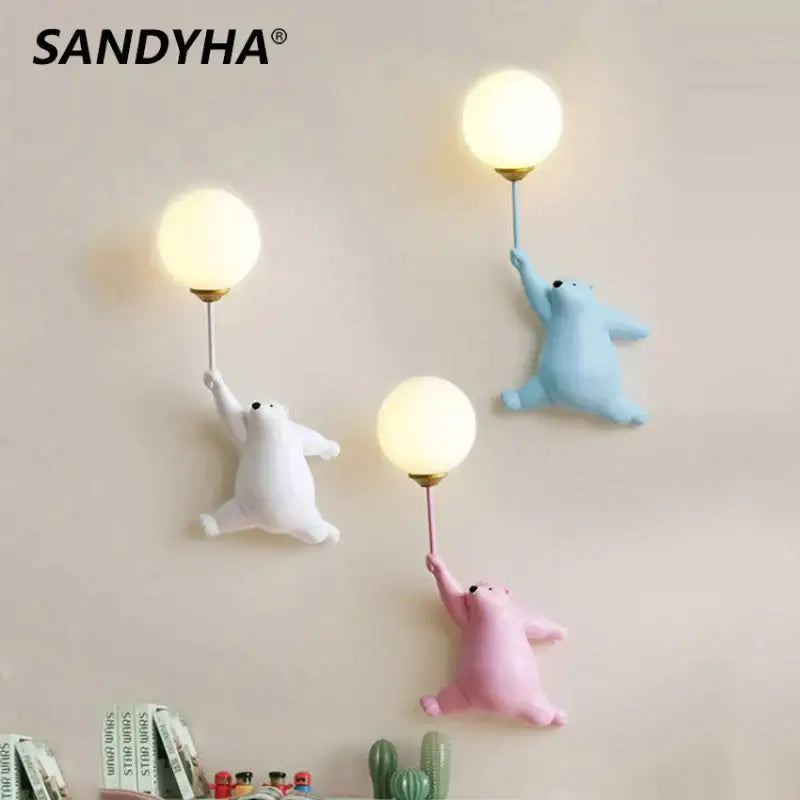 Sandyha bear wall lamp featuring three cartoon polar bears in white blue and pink holding glowing bulbs for bedroom use