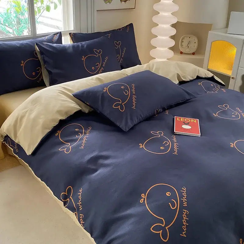 Navy blue duvet cover with embroidered gold whales and happy whale print in cute printed cotton decorbites bedding set