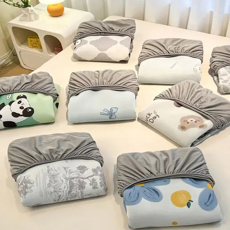Gray elasticated bedsheet covers with cute printed designs in pastel colors for decorbites cooling ice silk mattress set