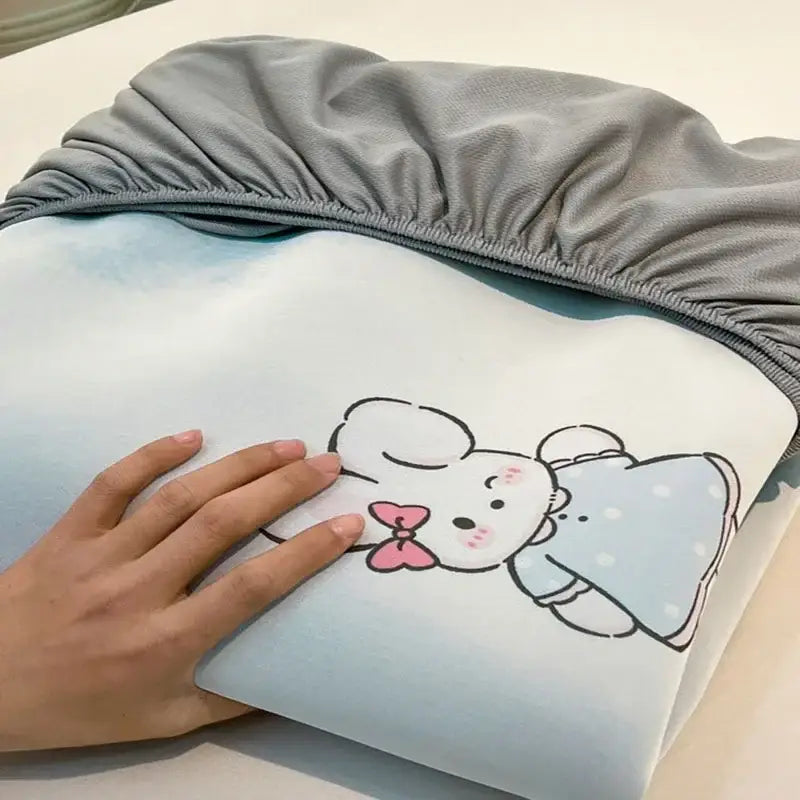 A soft light blue pillowcase with a cute bunny design in the decorbites cooling ice silk mattress set