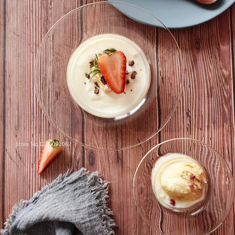 Clear glass bowl with subtle texture in a decorbites cute straw hat design holding white yogurt with strawberry and chocolate