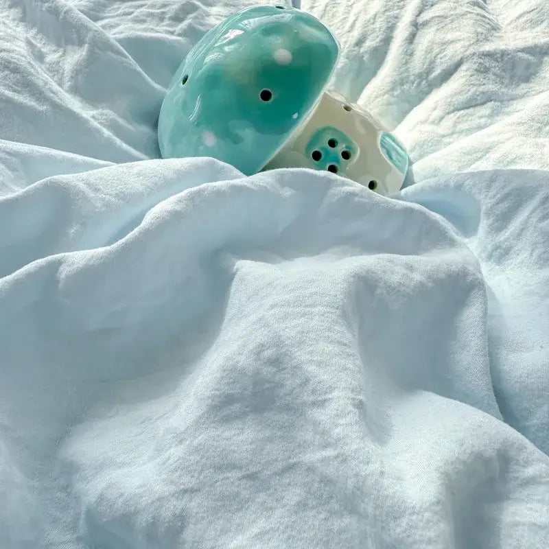Turquoise ceramic mushroom with white polka dots and black holes complementing cute teddy bear cartoon embroidery bed sets