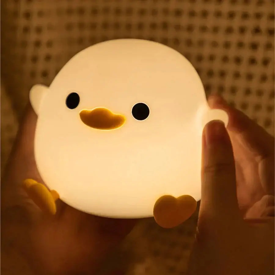 Cute white duck silicone night light with black eyes yellow beak feet and heart-shaped foot for bedroom decorbites duck silicone