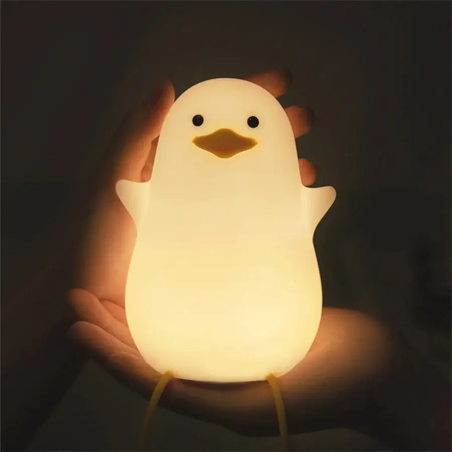 A soft glowing white duck silicone night light with black eyes and yellow beak for bedroom dimming decorbites duck silicone