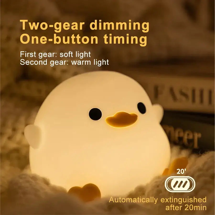 A soft glowing white duck silicone night light with black eyes and yellow beak for bedroom decorbites duck silicone lamp