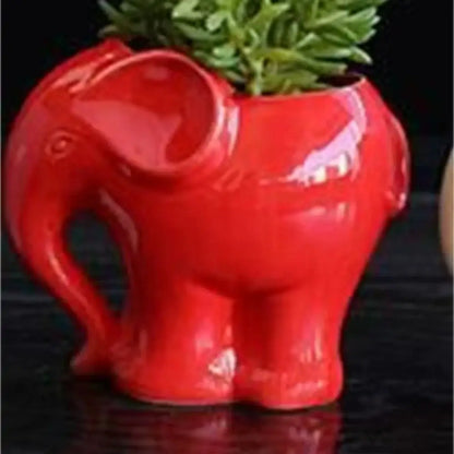 Vibrant red ceramic elephant succulent planter with glossy finish holding green succulent foliage for bedroom decor