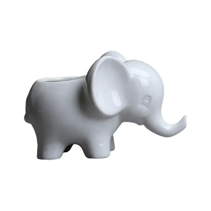 White ceramic elephant succulent planter with glossy finish and hollow back for holding small plants or succulents