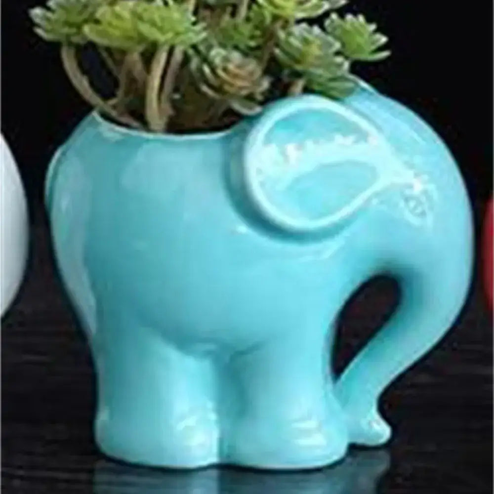 Turquoise ceramic elephant succulent planter with glossy finish featuring a small succulent for bedroom decor