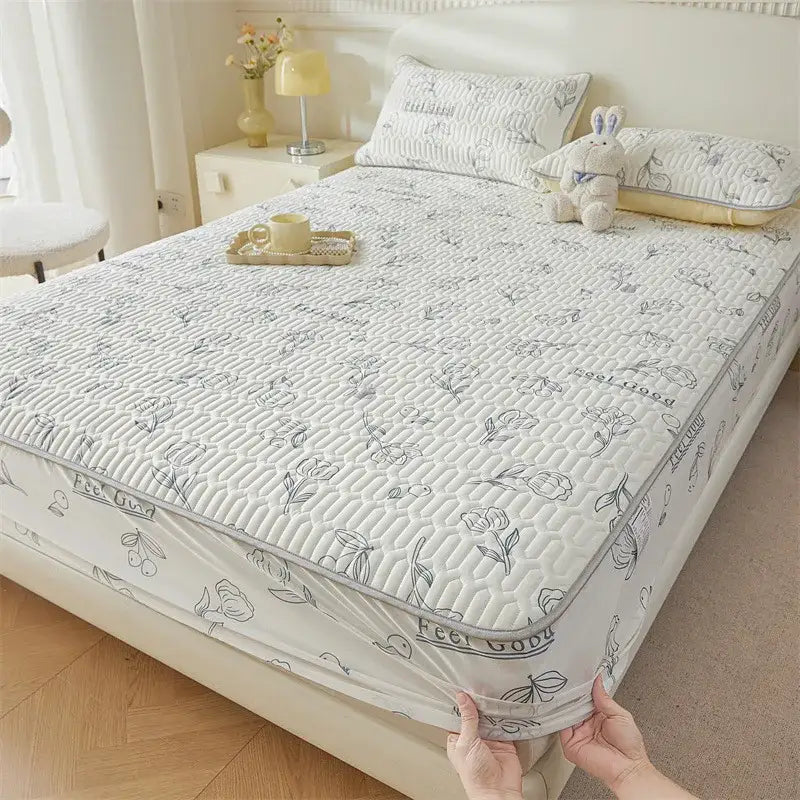 White quilted fitted sheet with gray floral and feel good text patterns featuring a cute cartoon pattern cooling design