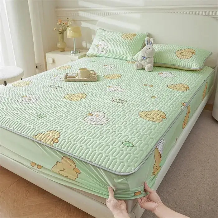 Light green quilted bed pad with cute cartoon pattern of yellow and white chicks for cooling fitted sheet use