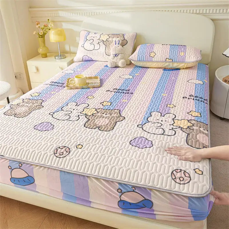 Pastel-striped bed pad with cute cartoon pattern of embroidered bears and stars in lavender blue and beige tones fitted sheet