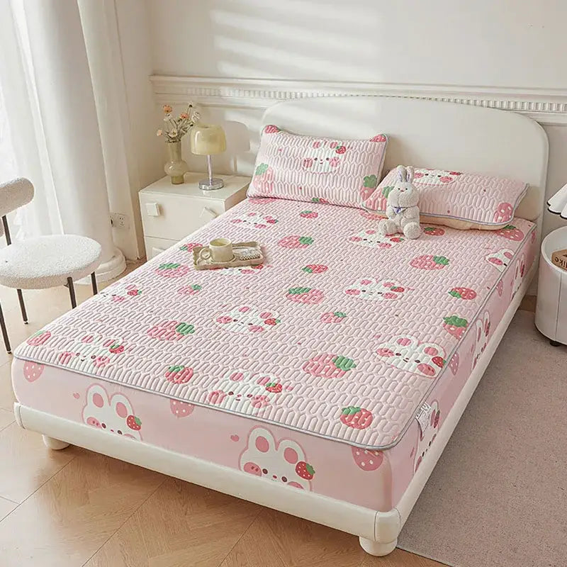 Pink quilted bed pad with cute cartoon pattern featuring bunnies and strawberries for cartoon pattern cooling fitted sheet
