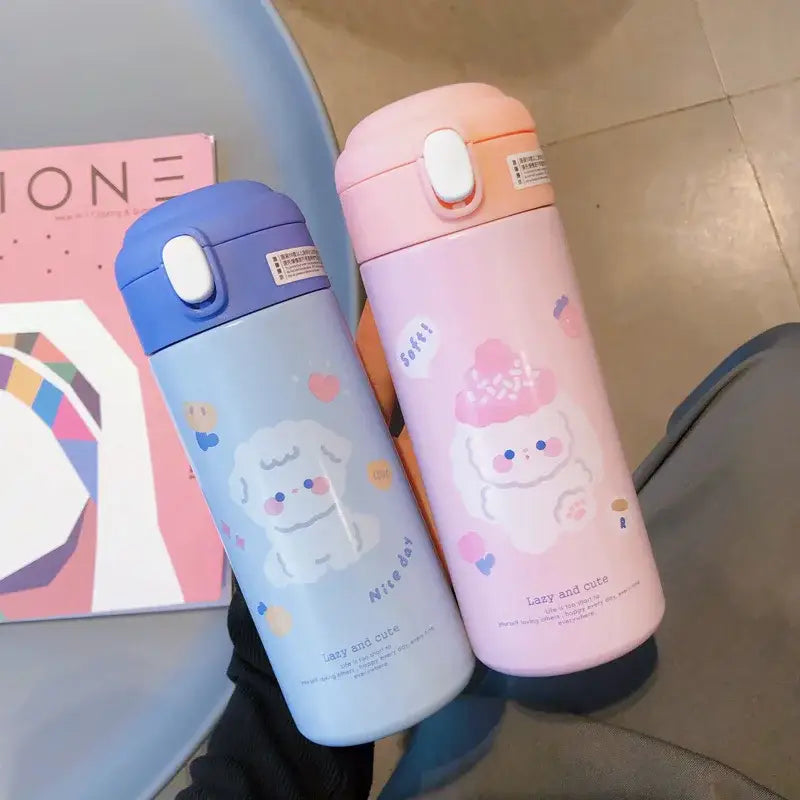 Two pastel-colored pink and white stainless steel vacuum flask straw cups with cute puppy designs and white flip lids