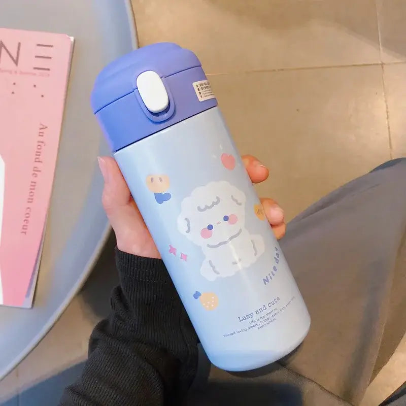 Light blue insulated vacuum flask with purple lid and white flip-top straw cup featuring a cute puppy design