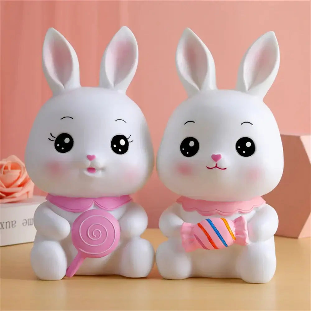 Two white ceramic bunny piggy banks with pink accents and candy-themed decorbites bunny money box for kids bedroom