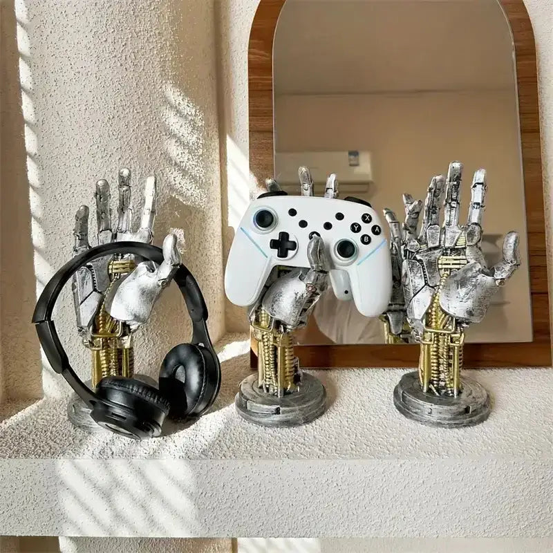 Cyberpunk silver and gold mechanical arm desktop stand holding white controller and black headphones gaming decorbites mechanical arm