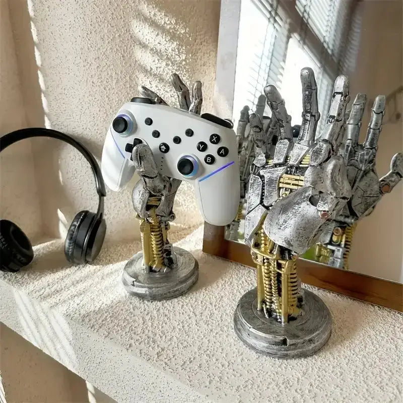 White nintendo switch pro controller held by a silver and gold cyberpunk mechanical arm desktop stand decorbites gaming decor