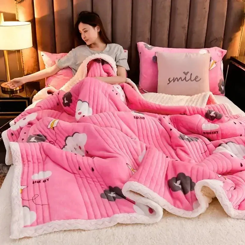 Pink plush blanket with white and gray cloud patterns featuring cozy milk velvet texture and ribbed edges for bedroom warmth