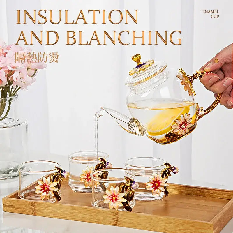Clear glass teapot set with gold enamel floral decorations and matching crystal glass cups for dining room use