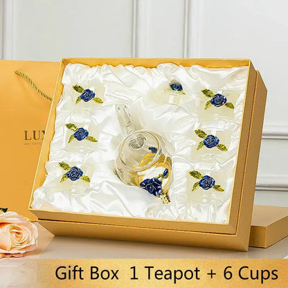 Elegant crystal glass teapot set with six matching cups featuring intricate blue rose embellishments for dining room use