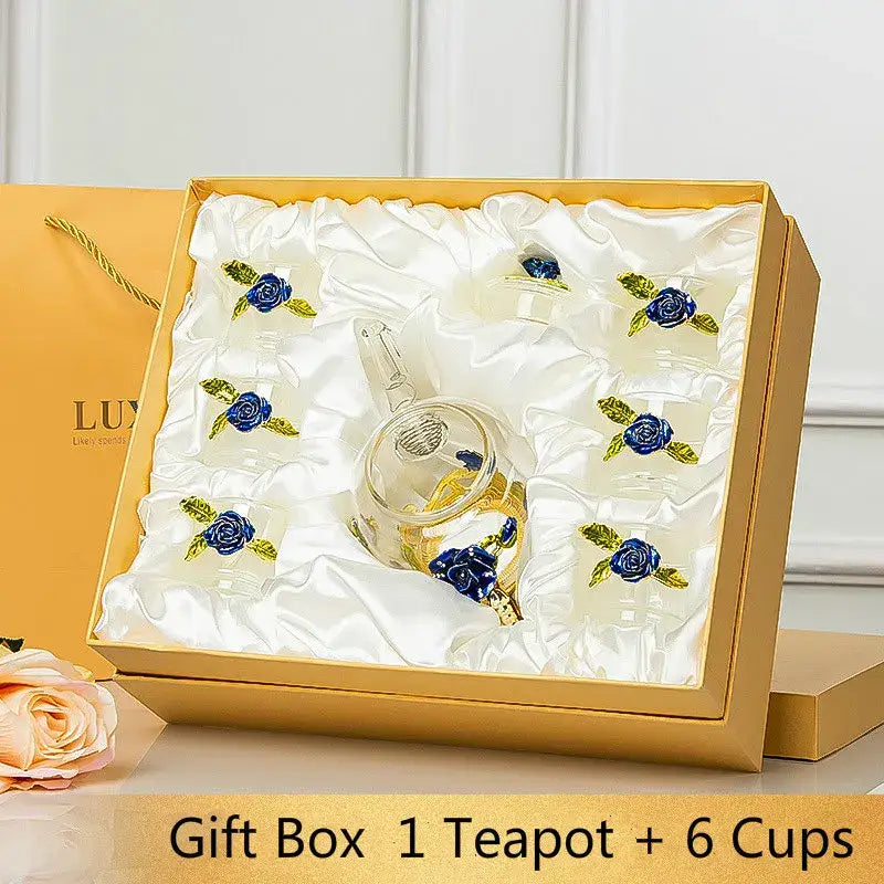 Elegant crystal glass teapot set with six matching cups featuring intricate blue rose embellishments for dining room use