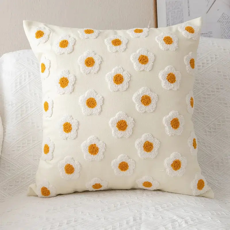 Cream-colored cushion cover with embroidered white and mustard-yellow daisy flora design for decorbites daisy flora decor