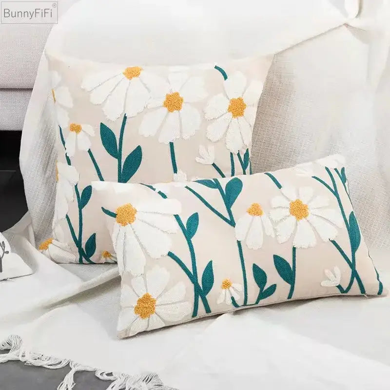 Cream-colored rectangular pillow cover with embroidered white daisies and teal stems for decorbites daisy home decor