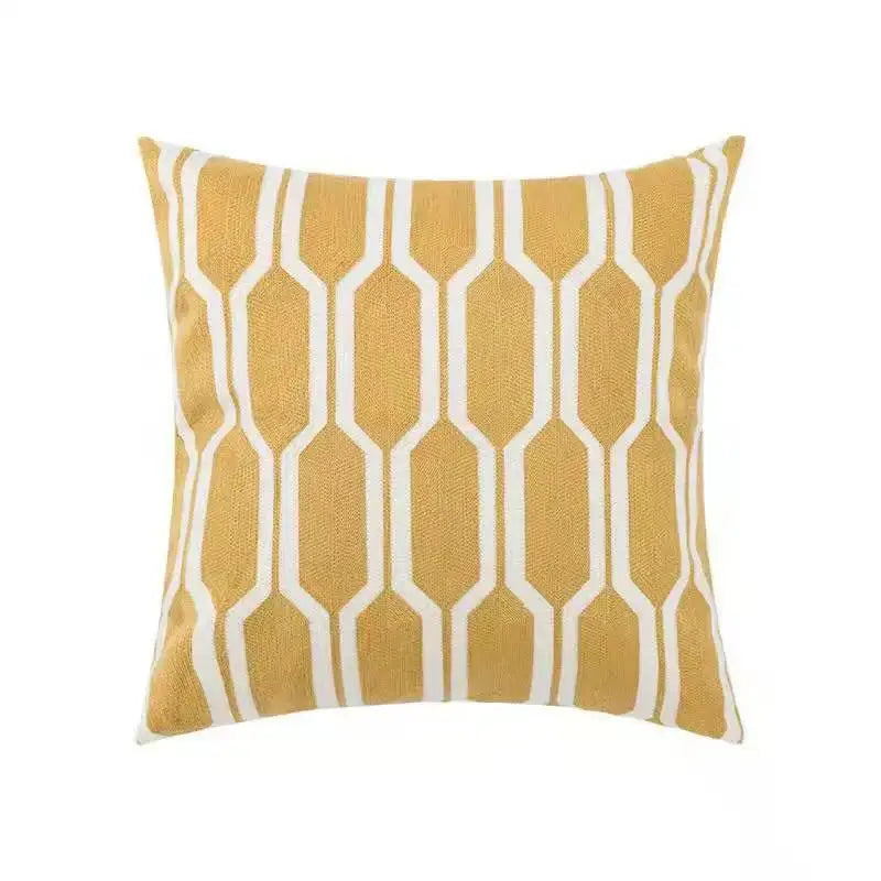 A mustard-yellow square cushion with white hexagon pattern pillow cover for decorbites daisy home floral bedroom decor