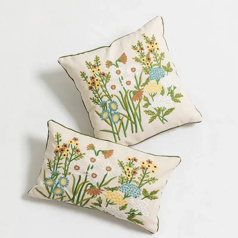 Cream-colored pillow cover with daisy floral embroidery in blue yellow and green for bedroom decorbites decor