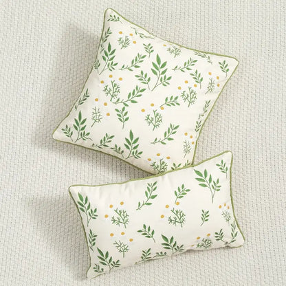 Cream-colored cushion cover with daisy floral embroidery and green leaf patterns by decorbites for living room decor