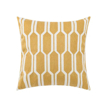 A square throw pillow with mustard yellow base and white geometric embroidery for decorbites daisy floral decor