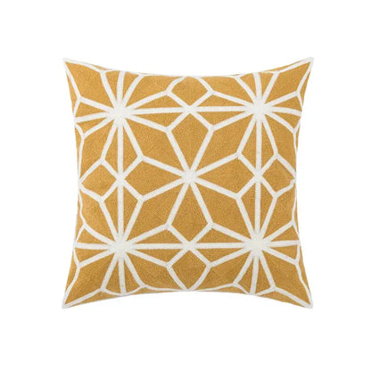 A square throw pillow with mustard yellow base and white geometric embroidery starburst patterns for decorbites daisy floral geometric decor