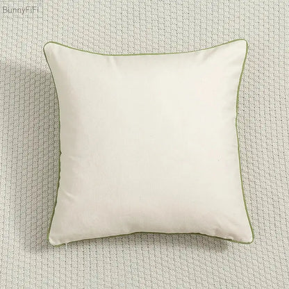 Cream-colored cushion cover with subtle olive green piping featuring decorbites daisy floral green leaves embroidery