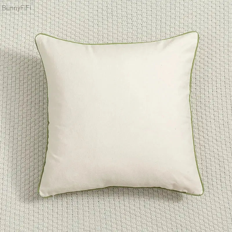 Cream-colored cushion cover with subtle olive green piping featuring decorbites daisy floral green leaves embroidery