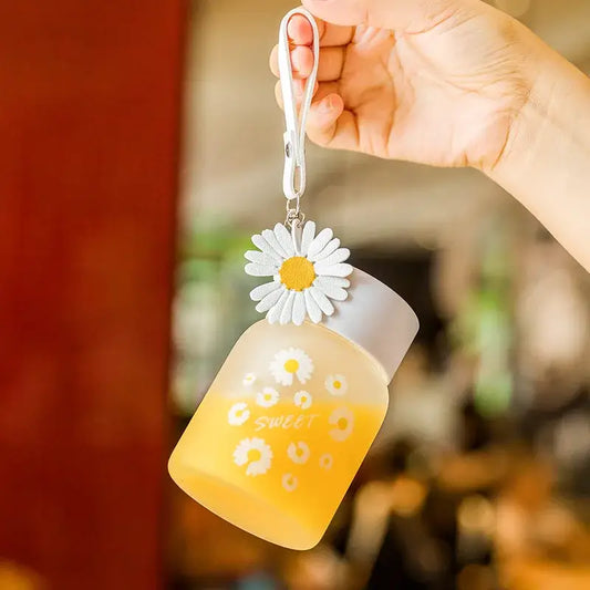 Yellow and white translucent daisy flower glass water bottle with decorbites daisy flower charm keychain