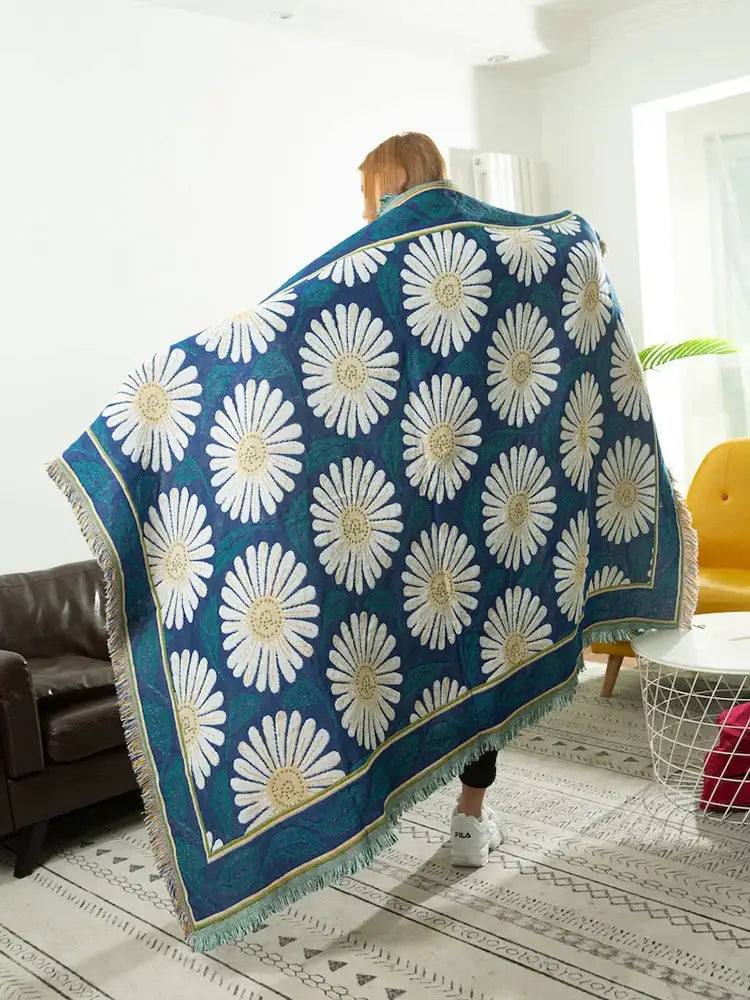 Teal daisy flower knitted blanket with bold white and yellow daisies and fringe for navy and white living room decorbites throw