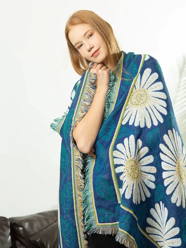 A vibrant blue daisy flower knitted blanket featuring large white daisies and decorative fringe for living room decorbites decor