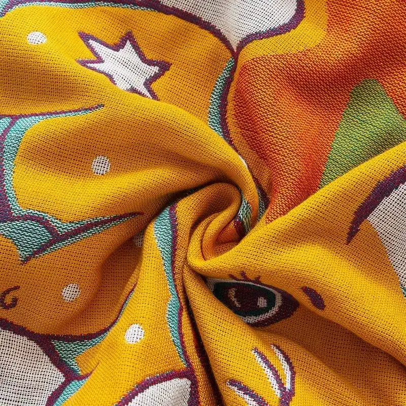 Vibrant yellow scarf with stars and eyes design displayed with daisy pattern light blue double cotton blanket bed cover