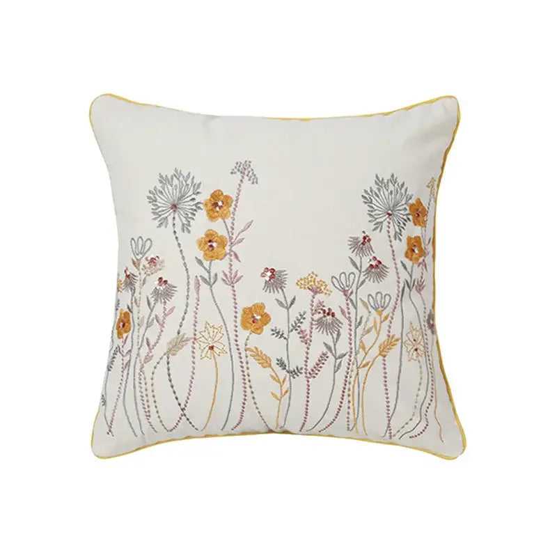 Cream-colored square pillow cover with delicate dandelion floral embroidery in yellow gray and muted pink for decorbites decor