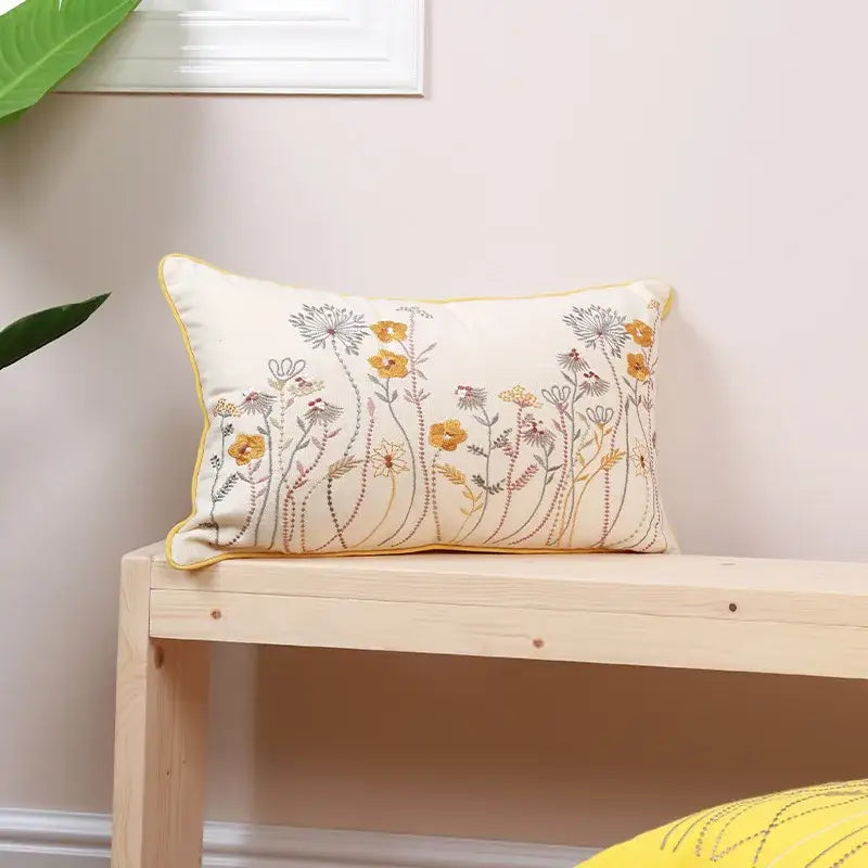 Cream-colored pillow cover with delicate yellow and gray dandelion floral embroidery for decorbites dandelion floral decor